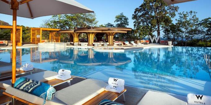 <p>W Costa Rica - Reserva Conchal is an upscale resort situated in Playa Conchal, Costa Rica. This stylish and contemporary retreat offers a unique blend of luxury, nature, and vibrant design. The resort features spacious and modern guest rooms and suites, each meticulously designed with a fusion of local inspiration and contemporary flair. Guests can enjoy breathtaking views of the ocean, gardens, or golf course from their balconies or terraces. The resort offers an array of amenities, including a freeform swimming pool, a full-service spa, and a fitness center. For dining options, guests can savor delicious international cuisine at the on-site restaurants and enjoy handcrafted cocktails at the bars. The resort also offers a range of outdoor activities, including golf, snorkeling, and kayaking. With its stunning beachfront location, luxurious accommodations, and impeccable service, W Costa Rica - Reserva Conchal promises an unforgettable and indulgent experience in Playa Conchal. Hotel amenities include a golf course, two swimming pools: one of them is the infinity pool for adults only and the pool for families and children located in the Zona Azul Beach Club, fitness center, bars, restaurants, and meeting rooms. There is also a full-service spa, and both valet plus self-parking are available free of charge.</p>